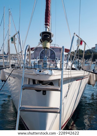 sailboat anchored in port, front view