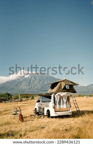 Camper van with mountain views in the background, the mountain is named Mount Agung, located in the Tianyar Savana area, Bali Indonesia Royalty-Free Stock Photo #2289436121