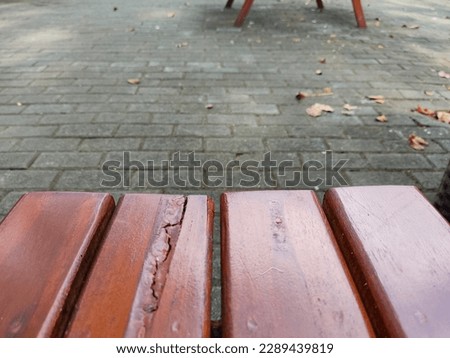 Photograph of close up wooden park bench with copyspace. Fit for background design, banner background, poster, Mock up display of product, banner for advertise online, etc.