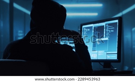 Computer Hacker in Hoodie. Obscured Dark Face. Concept of Hacker Attack, Virus Infected Software, Dark Web and Cyber Security. Royalty-Free Stock Photo #2289453963