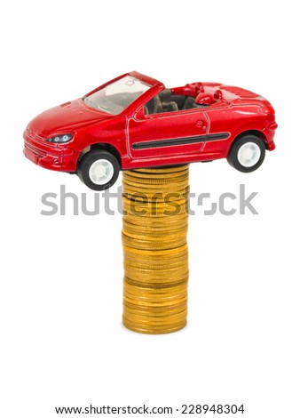 Toy car and stack of coins isolated on white background