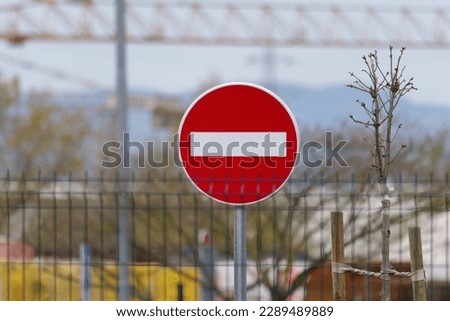 Close-up photo of a No Entry Traffic Sign placed behind the wire fence