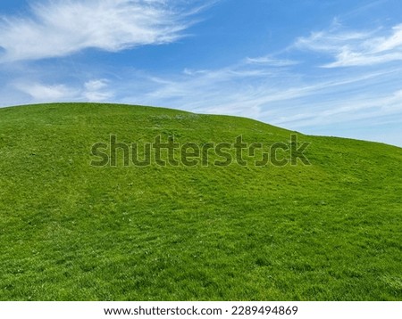 Idyllic Green Hill and Meadow Outdoor Springtime Scene Royalty-Free Stock Photo #2289494869