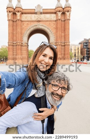 Happy senior couple having fun taking selfie portrait during vacation. Mature male and female tourist enjoying holidays in Barcelona. Happy people lifestyle