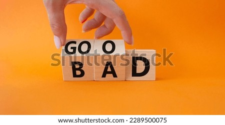 Good vs Bad symbol. Businessman Hand turns cubes and changes word Bad to Good. Beautiful orange background. Business and Good vs Bad concept. Copy space