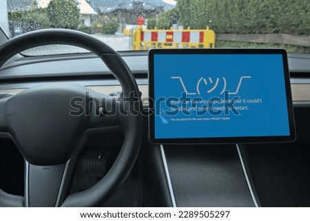 Smart Car with Blue Screen. This hypothetical picture shows a situation that no driver wants to see. Software Malfunction causing an Error and Issues while driving.