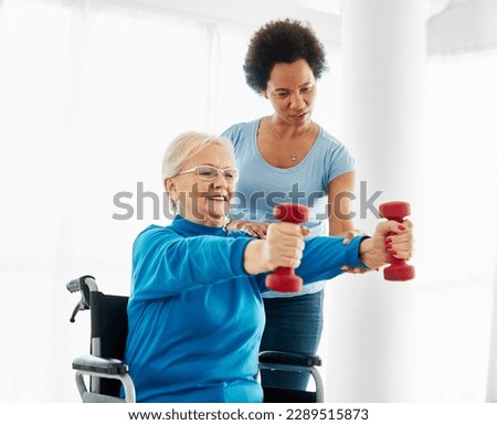 Doctor or nurse or physiotherapist caregiver exercise with senior woman at clinic or nursing home, person with chronic health condition, people with disability, person with paraplegia Royalty-Free Stock Photo #2289515873