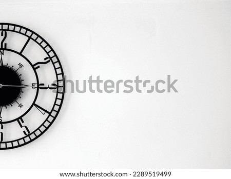 A half of the wall clock placed in the left side of the background to create a black and white poster, template or texture for marketing or sales in business or time related services 
