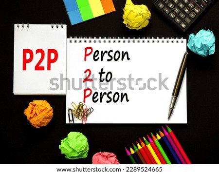 P2P person to persons symbol. Concept words P2P person to person on white note on a beautiful black background. Pencil and pen. Calculator. Business and P2P person to persons concept. Copy space.