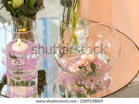 Wedding decor on the table with a vase of flowers and candles on a white background