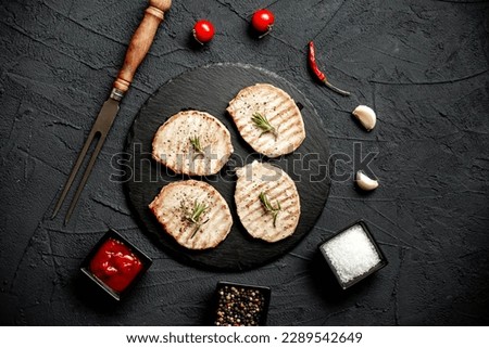grilled pork steaks on stone background 