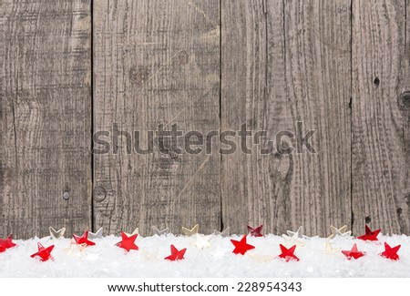 White snow and stars against old wooden boards