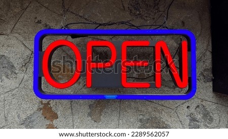 Open neon sign on the wall