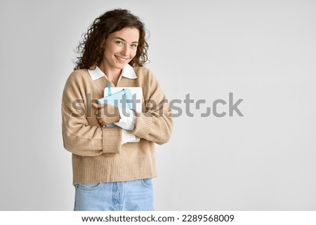 Young happy pretty cute girl student holding digital tablet standing isolated at white advertising online education course smart tech, studying abroad, university admission or getting scholarship.