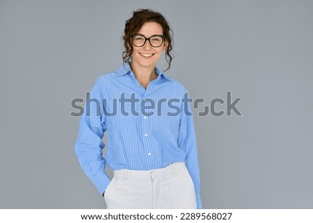 Happy young smiling confident professional business woman, happy pretty lady executive looking at camera, standing isolated at grey background, advertising commercial promo offer, portrait.