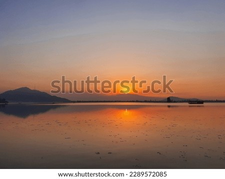 Dramatic sunset over the dal lake. Dramatic sunset sky with clouds.