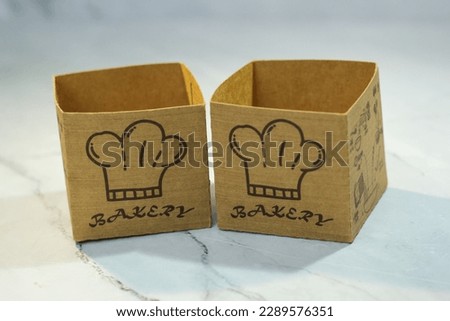 box-shaped brown paper containers or cups for muffins, Japanese cakes, cupcakes, empty. isolated.