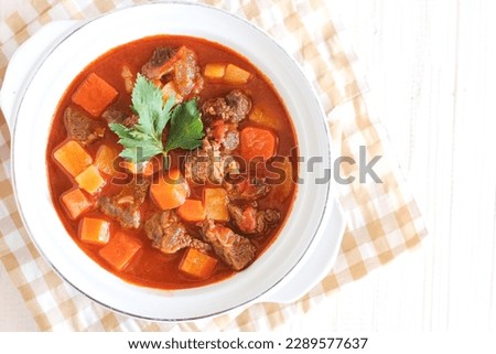 Gulasch or goulash in a white porcellain bowl. originated from Hungaria. perfect for recipe, article, or any cooking contents.  Royalty-Free Stock Photo #2289577637