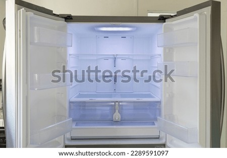 Open empty refrigerator. Refrigerator open empty fridge inside interior. Close up on empty refrigerator with door open. New clean refrigerator. Royalty-Free Stock Photo #2289591097