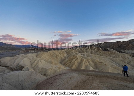 Photographer taking picture of the sunset landsacpe of the Zabriskie Point at Death Valley National Park, California