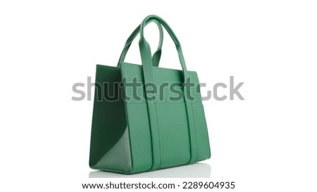 Women's green handbag on a white background with reflection Royalty-Free Stock Photo #2289604935