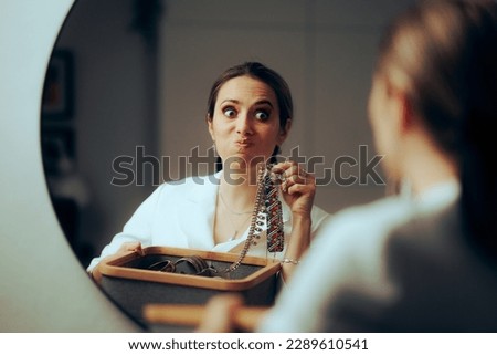 
Woman looking in the Mirror Checking her Jewelry Box
Stylish snobbish lady choosing which necklace to wear 
 Royalty-Free Stock Photo #2289610541