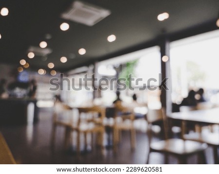 Blurred images of the coffee shop cafe interior background and lighting bokeh