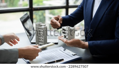 Signing a contract. Client and broker agent, lease agreement, successful deal and Young business sitting at the desk in modern office 

