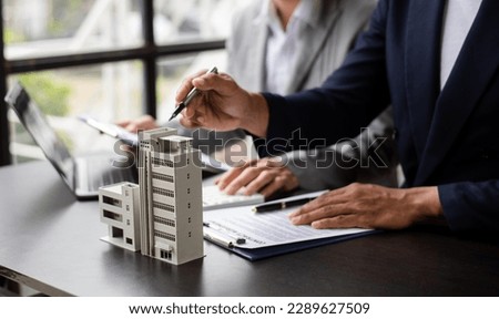 Salesman Hands On House Model , Small Toy House Small Mortgage Property insurance and concepts real estat in office Royalty-Free Stock Photo #2289627509