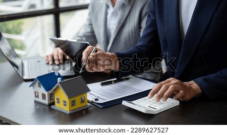Real estate broker agent presenting and consult to customer to decision making sign insurance form agreement, home model, concerning mortgage loan offer in office
 Royalty-Free Stock Photo #2289627527