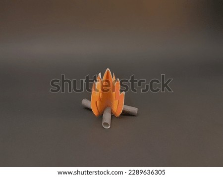 camp fire bonfire bale fire fireplace orange red fire woods origami paper art isolated on dark background