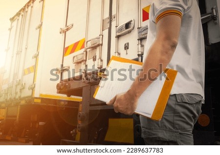 Truck Drivers Hold a Clipboard The Checking Container Door. Security of Cargo Shipping. Inspection Safety Checks Before Driving. Delivery Freight Truck Logistics Transport. Royalty-Free Stock Photo #2289637783