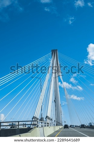 Modern bridge pylon against a blue sky. Detail of the multi-span cable-stayed bridge. Linear perspective view of a white cable-stayed suspension Alex Fraiser Bridge in BC. Nobody, selective focus Royalty-Free Stock Photo #2289641689