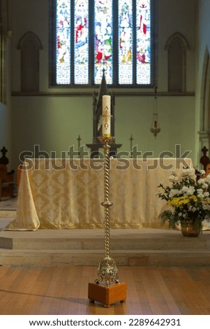 Hobart, Tasmania, Australia, May 14, 2015: View of the altar with a candle on a large brass candle holder inside St Marys cathedral Royalty-Free Stock Photo #2289642931