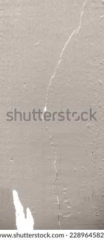 Gray wall background. The wall is cracked. White cracks can be seen.