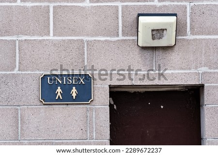 Unisex toilet sign for all genders at public facility