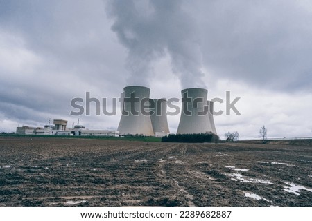 
The cooling towers of the Temelín nuclear power plant with a cloudy sky in the background. Nuclear power plant.