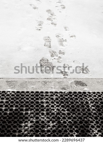 footprints on freshly fallen snow in front of porch of residential building Royalty-Free Stock Photo #2289696437