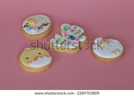 Happy Easter. Multicolored easter cookies on a pink background.