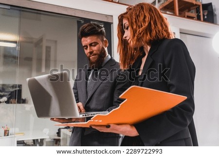 Business people work together in office with a laptop as a team and partner