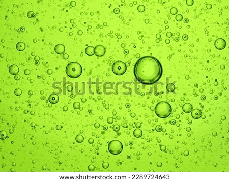 Oil bubbles close-up macro on a green background