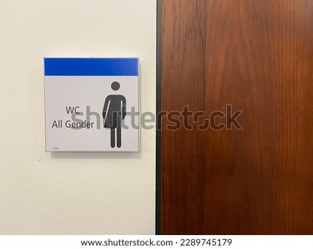 "WC All Gender" restroom sign written in English inside the main building at the University of Freiburg in Freiburg im Breisgau, Germany