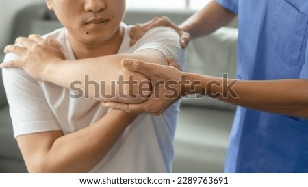 Athlete undergoing physiotherapy with a musculoskeletal specialist after sports and gym injuries. Royalty-Free Stock Photo #2289763691
