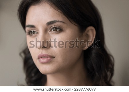 Close up young serious brunette Armenian woman staring into distance, think, looks deep in thoughts. Face of mindful thoughtful brown-eyed female, millennial generation person portrait, natural beauty Royalty-Free Stock Photo #2289776099