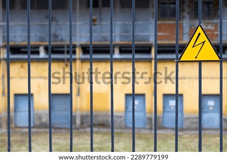 high voltage sign on the fence of a power plant. power station area