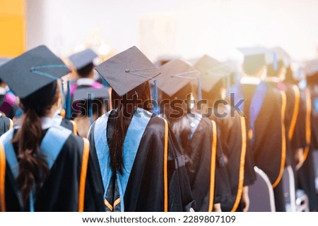 Rearview of university graduates wearing an academic gown on commencement day. Education stock photo Royalty-Free Stock Photo #2289807109