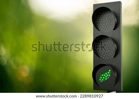 Traffic light with green leaf symbol. Decarbonization concept. Royalty-Free Stock Photo #2289810927