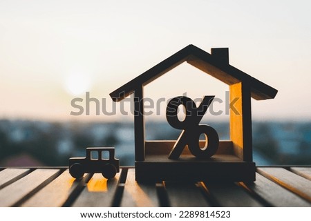 Wooden car model, Percentage and house sign symbol with sunlight, Concepts of home interest, real estate, a symbol for buying a new car, vehicle car auto repair service maintenance.