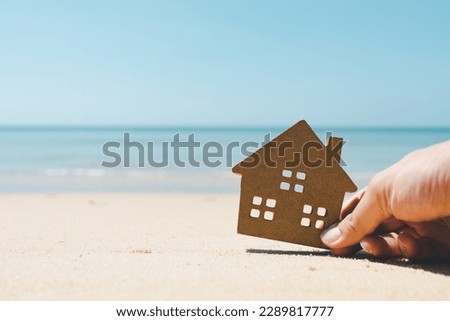 House model in sand , a symbol for construction , ecology, loan, mortgage, property or home, concept for housing problems.