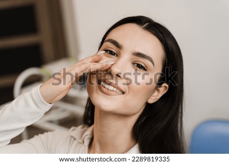 Girl touches her nose and smiles after septoplasty nose surgery correction deformities of the nasal septum. Happy patient of ENT doctor Royalty-Free Stock Photo #2289819335